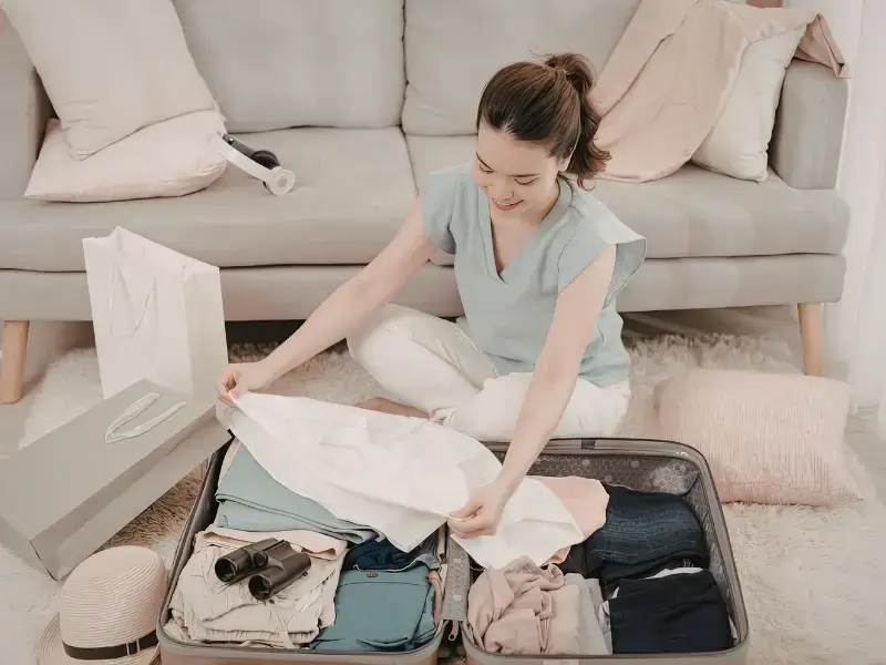 woman packing suitcase travel